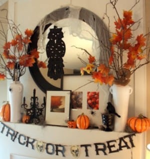 Fall Mantel with trick or treat garland and  fall branches in vases