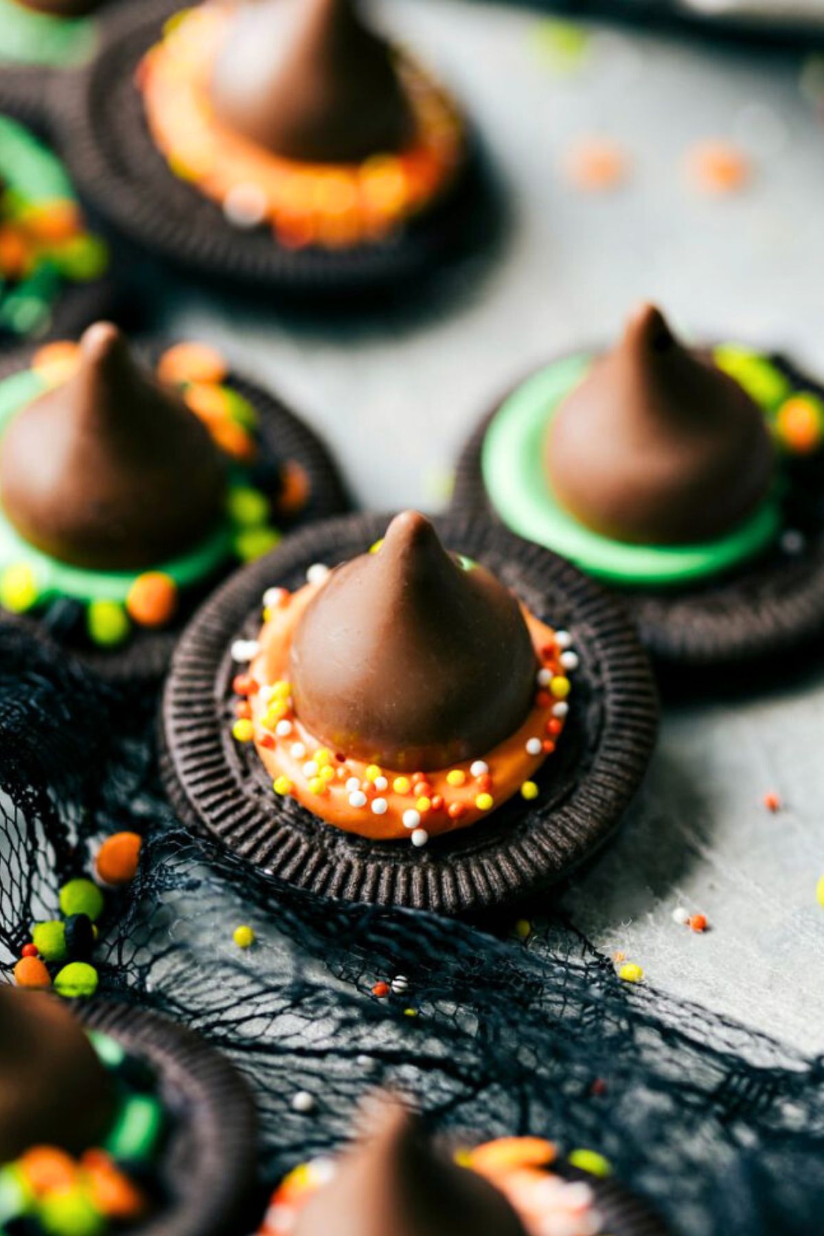 Halloween themed treats oreo cookies with a chocolate kiss on top to make them look like witch hats