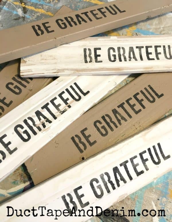 be grateful stenciled on old wood scraps