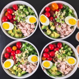 Cobb salads prepared in mason jars for meal prep.