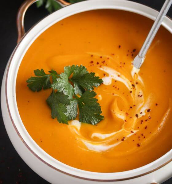 Slow cooker pumpkin soup in white bowl