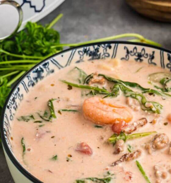 Crockpot tortellini soup in blue and white flowered bowl