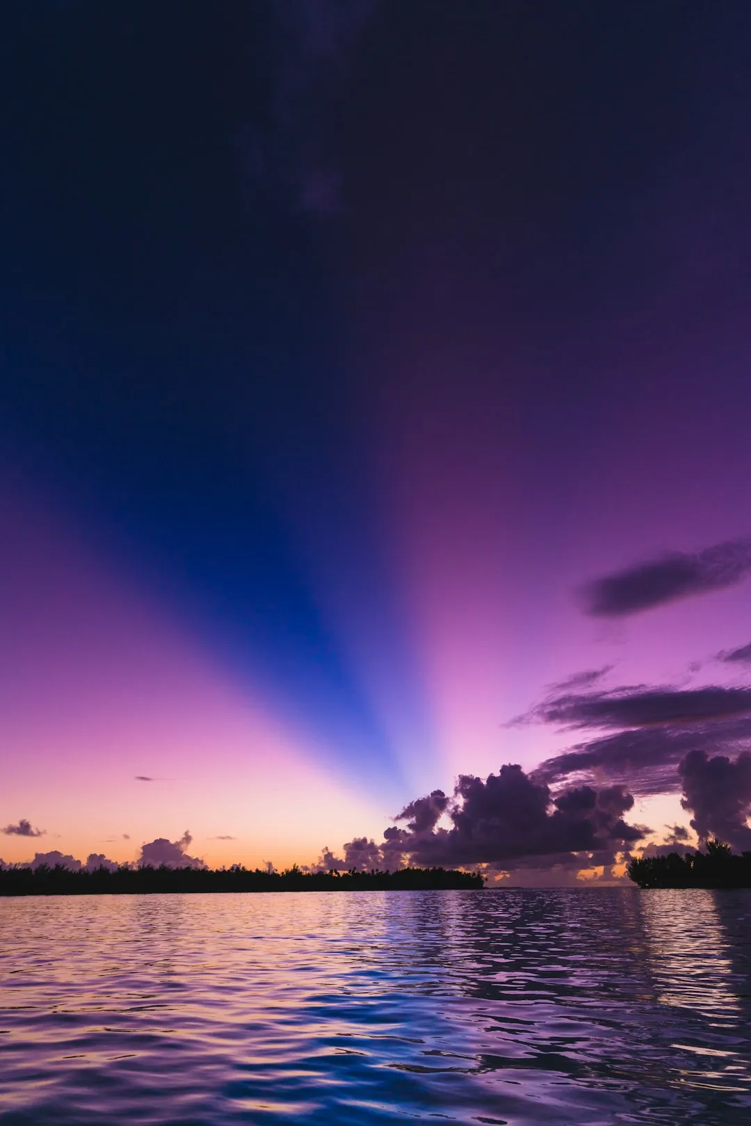 Sunset catamaran cruise across Bora Bora's glassy lagoon
