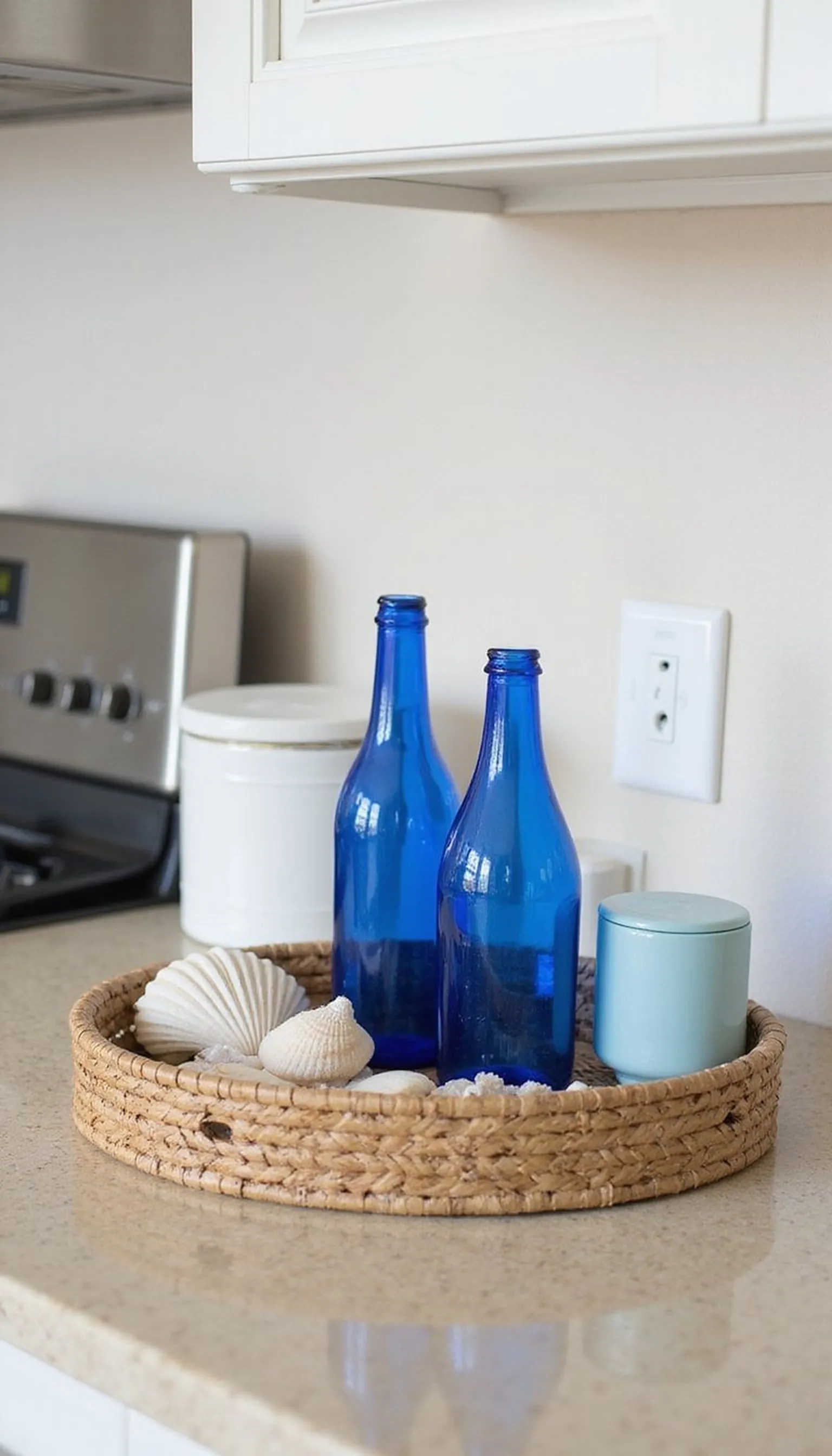 Coastal tray with shells and blue glass bottles
