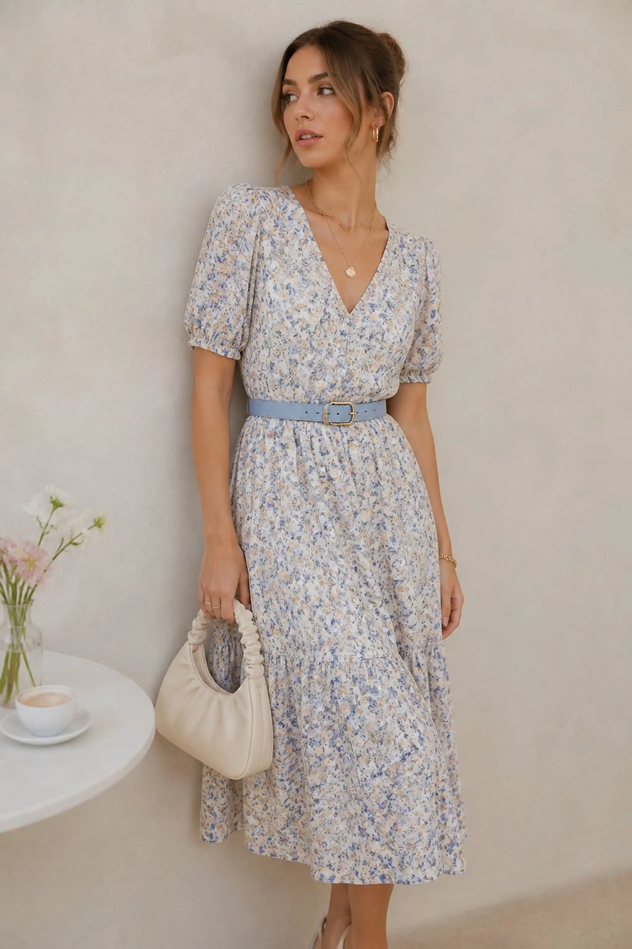 Powder blue belt cinching a floral midi dress