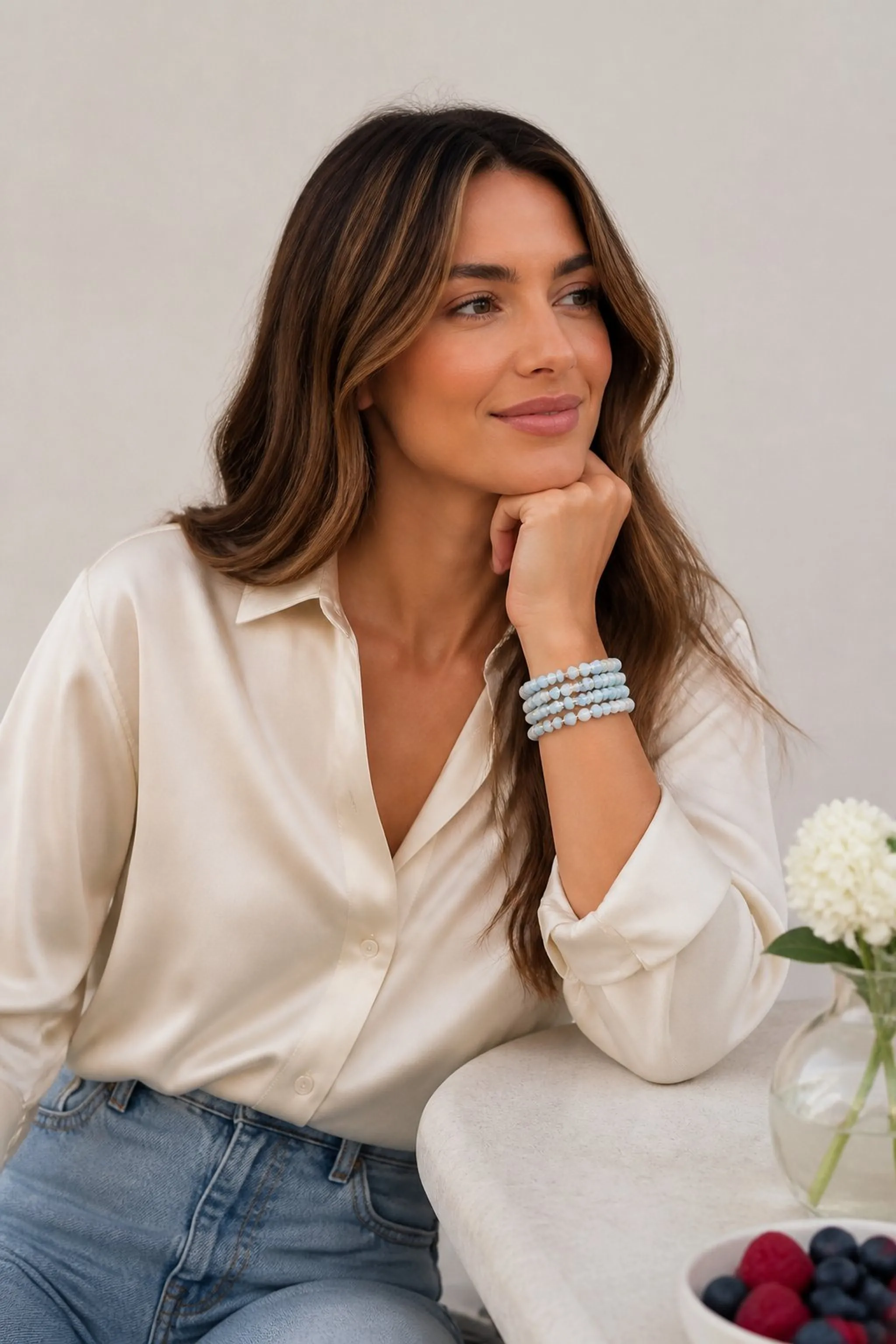 Sky blue beaded bracelets paired with cream blouse