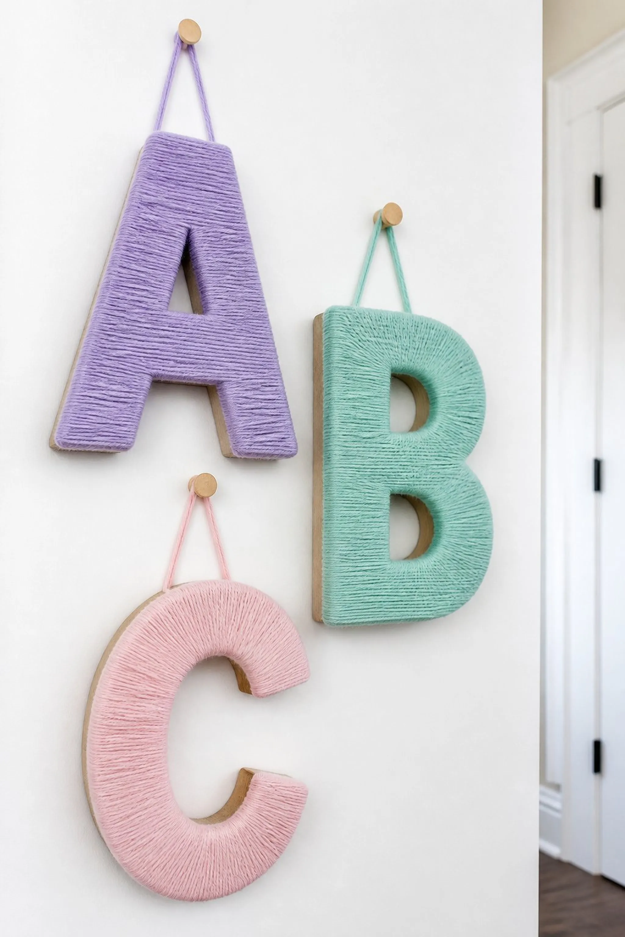 Pastel-colored yarn wrapped letters for personal touch