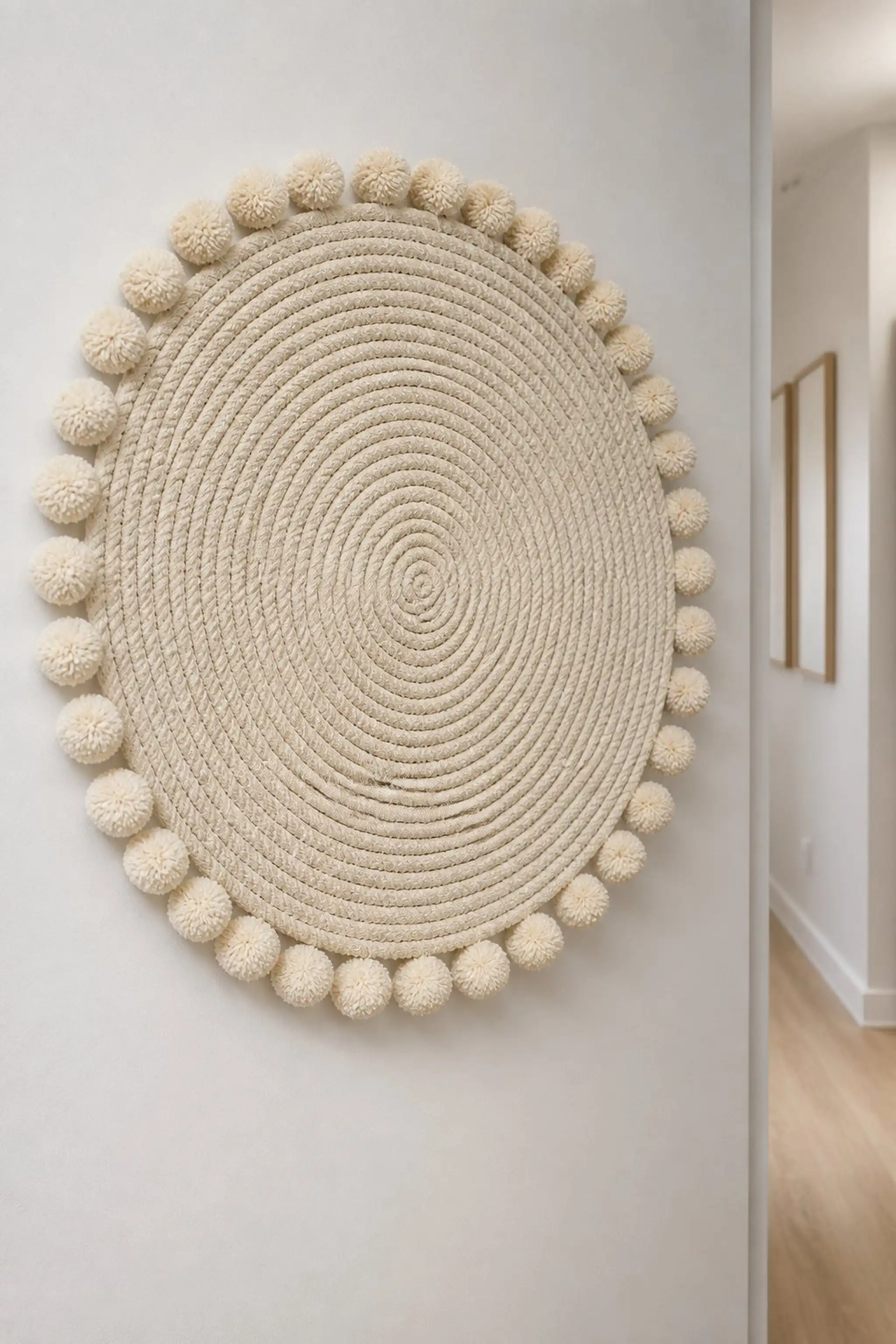 Textured yarn wall circle with pom-pom trim