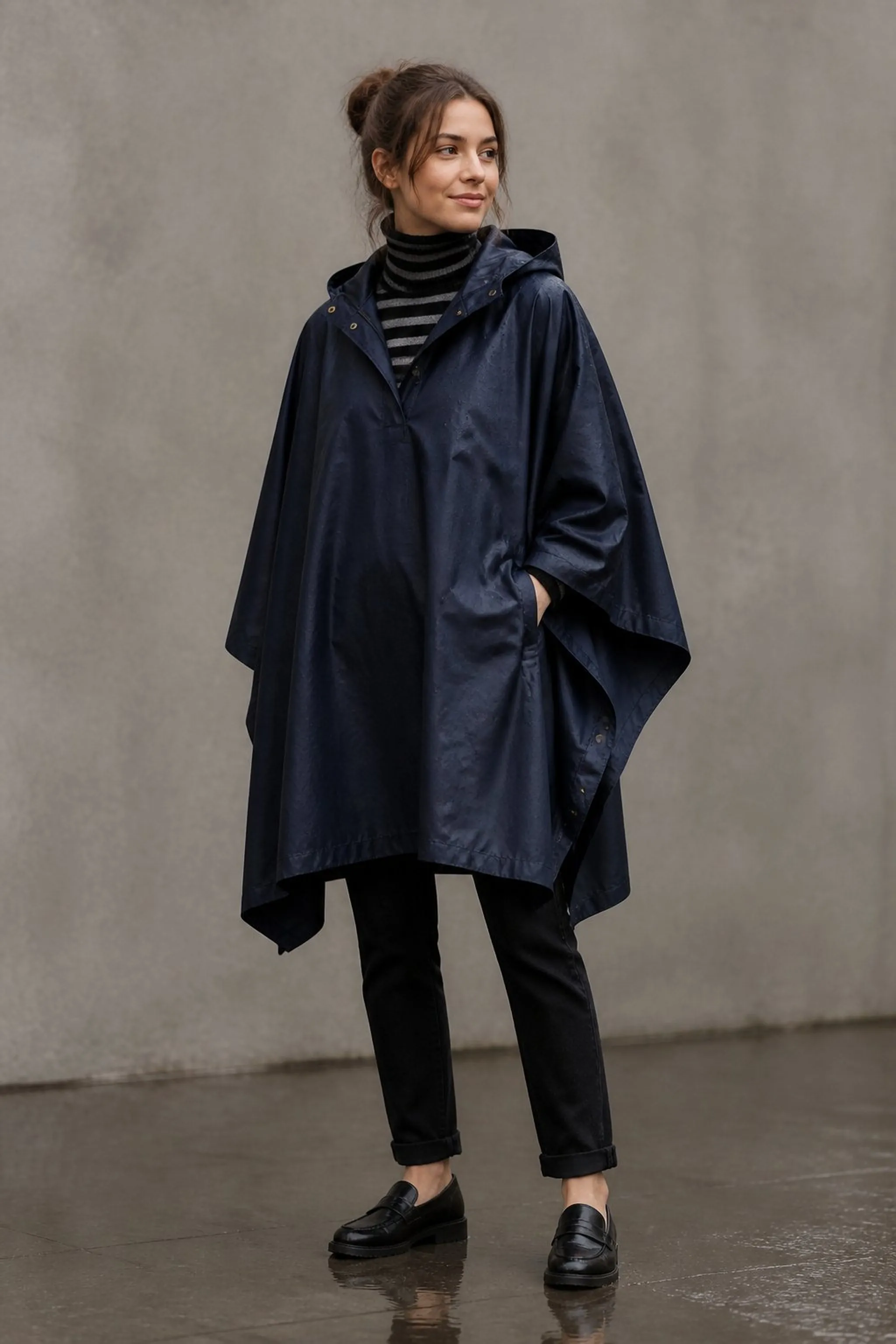 Textured rain poncho layered over striped turtleneck